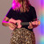 Lifestyle image of the Mad About Pink soprano ukulele being played. Lightweight beginner ukulele with carbon strings, geared tuning pegs and a compact 21-inch design, ideal for children, students and first-time players.