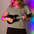 Lifestyle image of the Mad About Black soprano ukulele being played. Lightweight beginner ukulele with carbon strings, geared tuning pegs and a compact 21-inch design, ideal for children, students and first-time players learning chords, strumming and basic techniques.