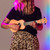 Lifestyle image of the Mad About Peach soprano ukulele being played. Lightweight beginner ukulele with carbon strings, geared tuning pegs and a compact 21-inch design, ideal for children, students and first-time players learning chords, strumming and basic techniques.