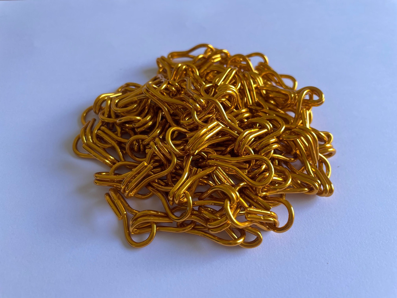 Golden Yellow Aluminium Chain. This chain is supplied in 600m boxes to allow you to create a project or to repair an older screen. The chain can be hung indoors or outdoors to create a barrier for air to flow though but pests to be stopped fro entering your workplace or your home.