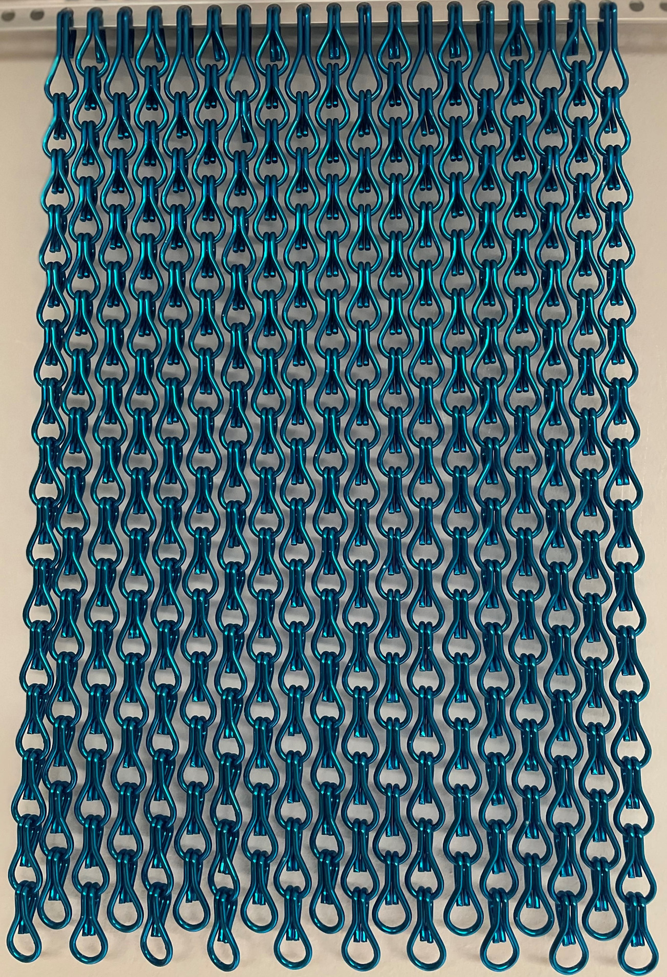 Metallic Blue Close Knit. A close knit screen has 22% more strands per metre than a standard screen. This close-knit chain screen is expertly designed to prevent flies, bugs, and other pests from entering your home or business, while still allowing for natural airflow and light. Ideal for both residential and commercial use, it offers an effective and stylish solution to keep your spaces pest-free. Enhance your environment with our durable, efficient, and aesthetically pleasing chain screens