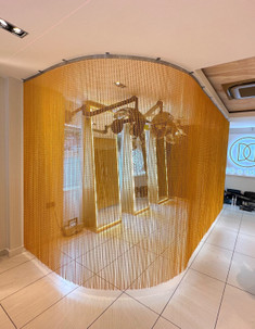Flexi Rail and Golden Yellow chain to use as a partition to separate areas in a hair salon. The Flexi rail was installed in a curve to create an area away from the main salon where customers could relax while they have a treatment.