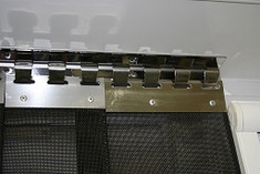 Plate Connecting Mesh to Header Rail. These allow the mesh to be removed easily for cleaning or if you need access to the full door.