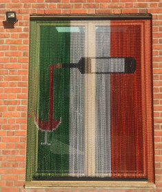 Bespoke screen made for patio door. The screen was made with Forest Green, Silver and Metallic Red.