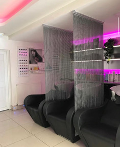 Bespoke design for a hair salon to separate the washing stations. This was created using a metro rail and close knit chain design.