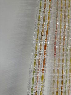 Close up of mixed Bead Fly Screen - Mixed strands of Crystal Valencia and Jelly Bean Barcelona. Supplied on a White bead header rail. This screen can be used indoors and will prevent flies, bugs and insects from entering your home.