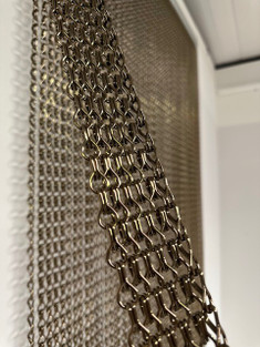 Chain link fly screen made with brown/bronze chain that was made as a sample. Image of the colour of chain that has been used. The rail used in this screen is different from the rail we now use. Measures 90cm x 210cm and can be used indoors or outdoors for pest control or can be used as a decorative screen.