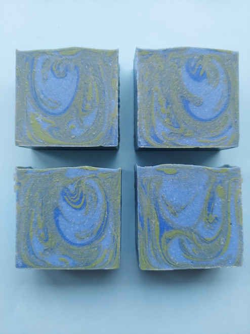 Image shows side view of 4 bars of soap. 
Soap has blue and green swirls.
