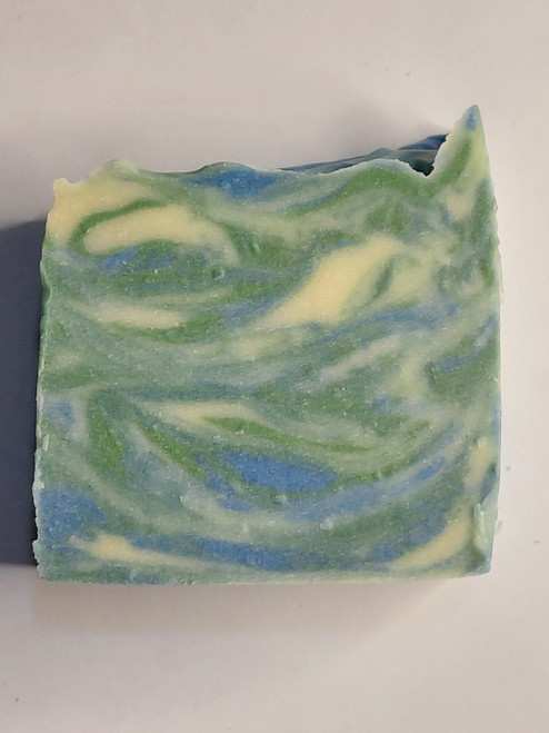 This soap has a white background with beautiful blue and green swirls.