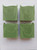 These bars have a lovely swirl pattern of light and dark green.
Image shows a side view of four bars of green soap.