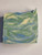 This soap has a white background with beautiful blue and green swirls.