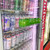 Display merchandise on cooler doors with suction cup shelves made from clear plastic