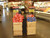 Display hanging sings above produce bins using pallet sign holders