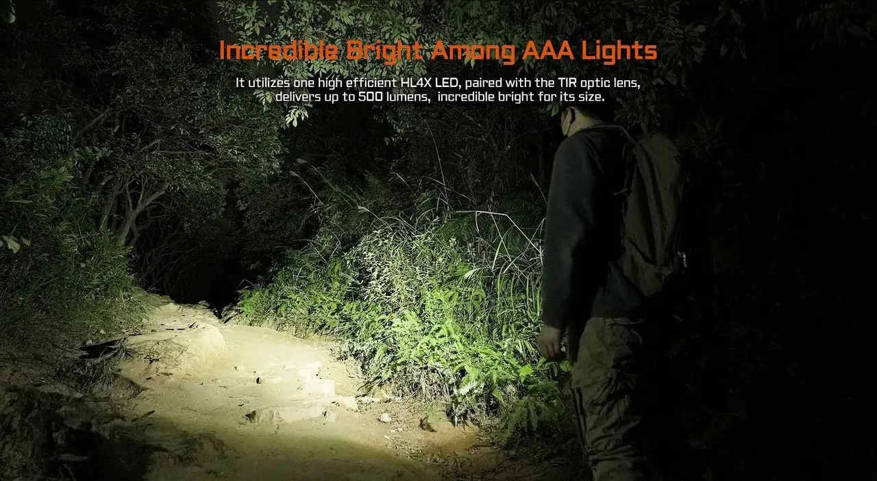 Person using the Acebeam PT20 penlight to illuminate a forest path, showcasing its incredible 500 lumen brightness.