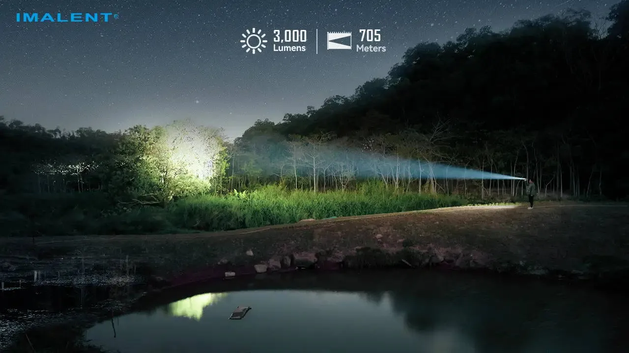 Imalent BTL50 flashlight illuminating a distant area by a pond, showing 3000 lumens and 705 meters range.