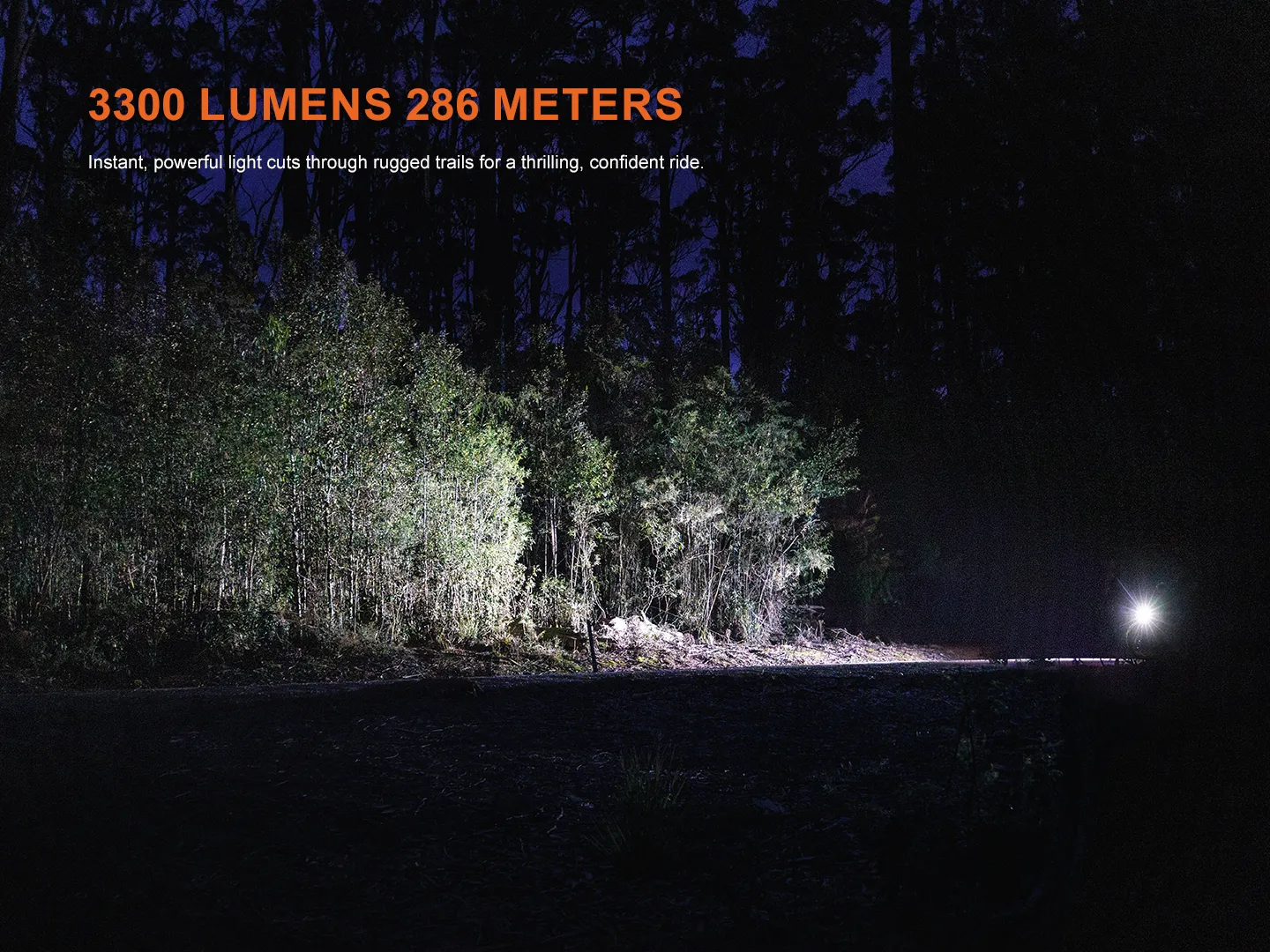 Powerful 3300 lumens beam of the Fenix BC45R bicycle light illuminating a dark forest trail at night.