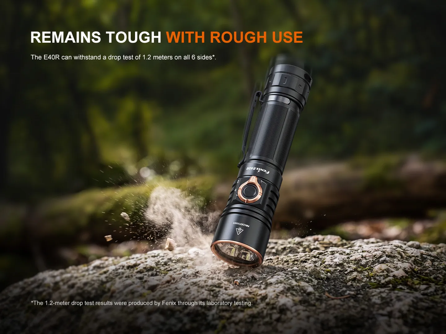 Fenix E40R - 5000 Lumen Rechargeable EDC Torch on rocks with dust, demonstrating its tough, impact-resistant design.