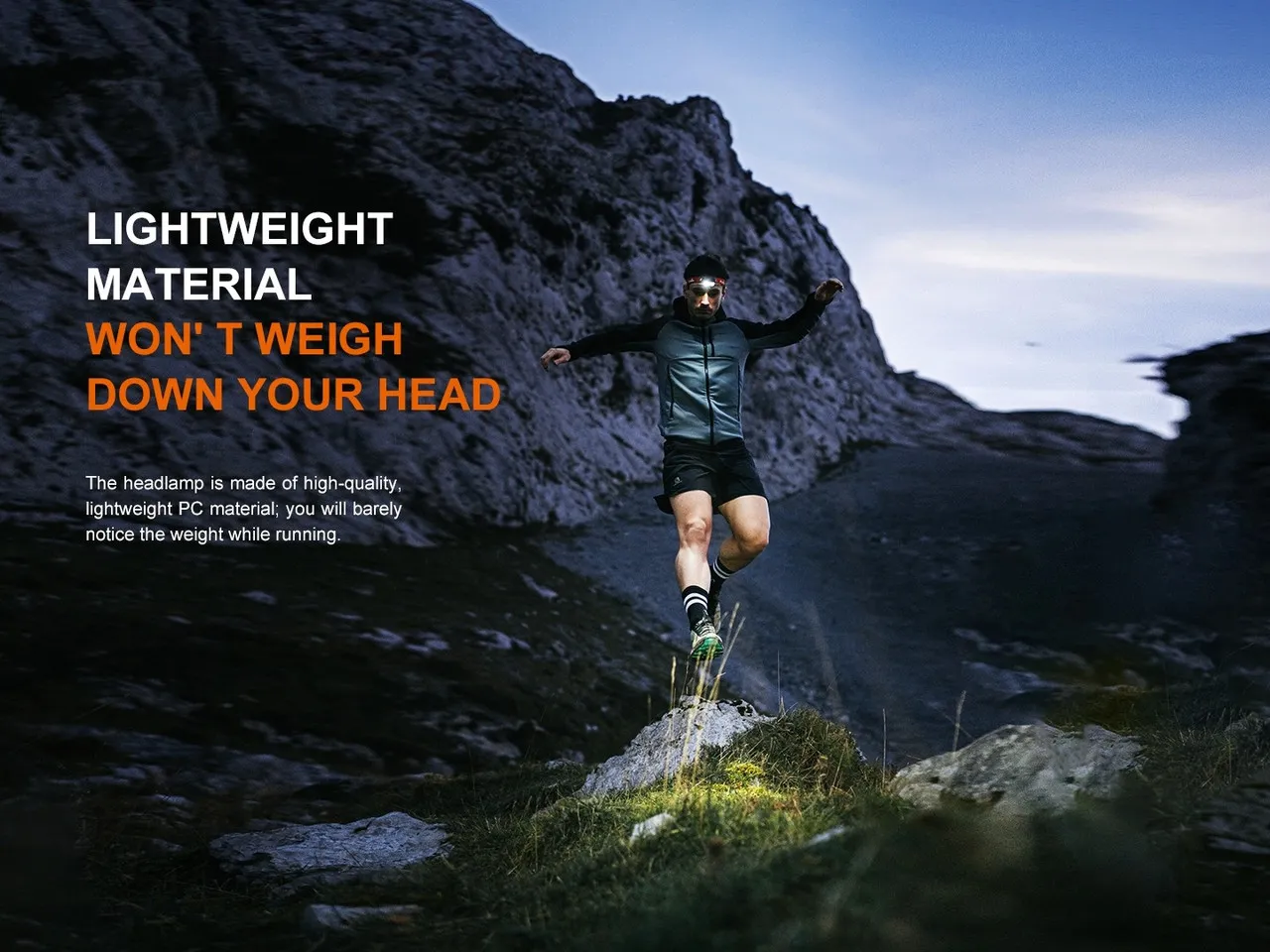 Trail runner wearing the Fenix HL18R-T V2.0 Lightweight 800 lumen rechargeable trail-running headlamp in mountains.