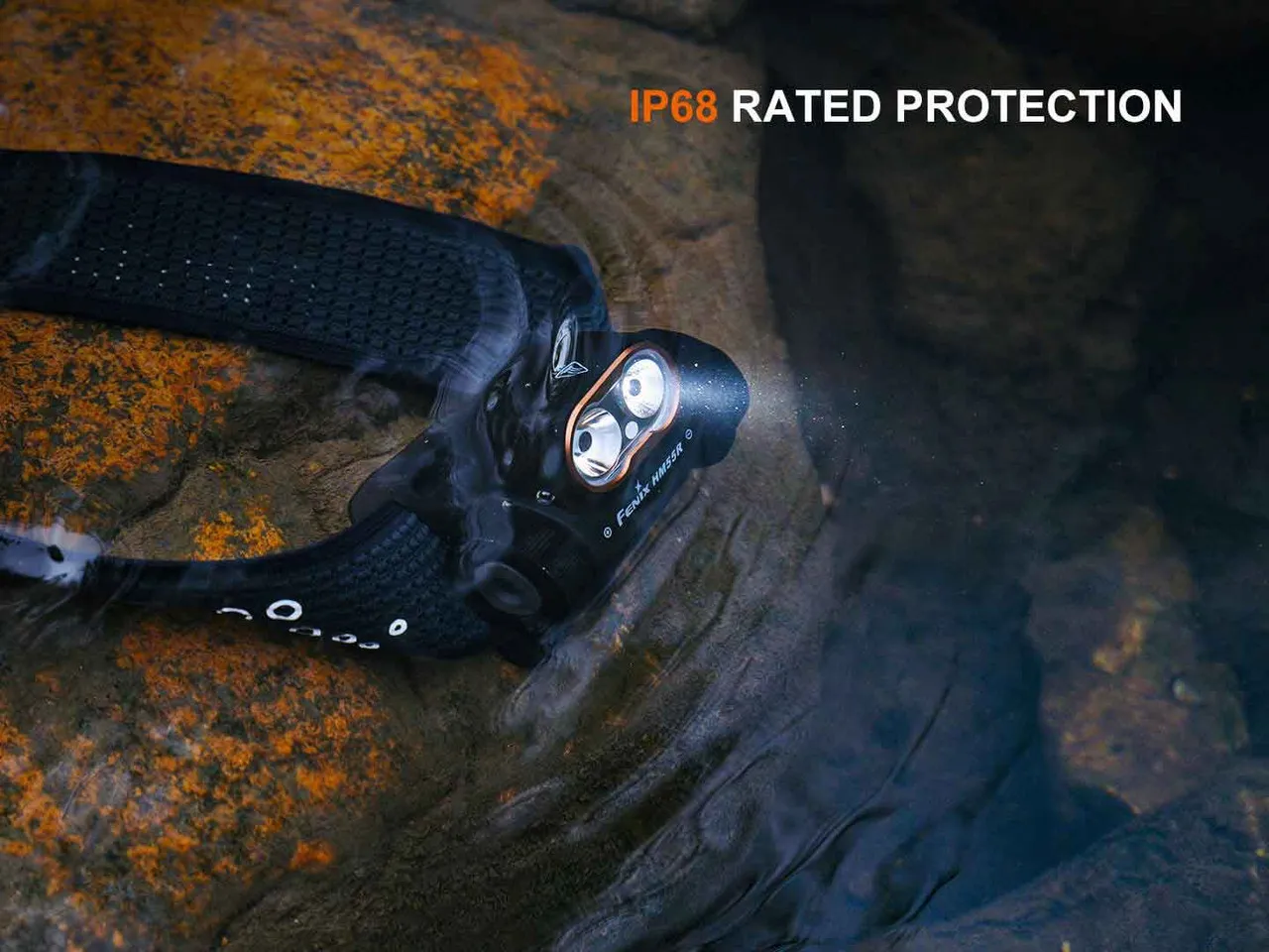 Fenix HM55R 1200 Lumen Lightweight Multi-LED Rechargeable Headlight submerged in water, showing IP68 protection.