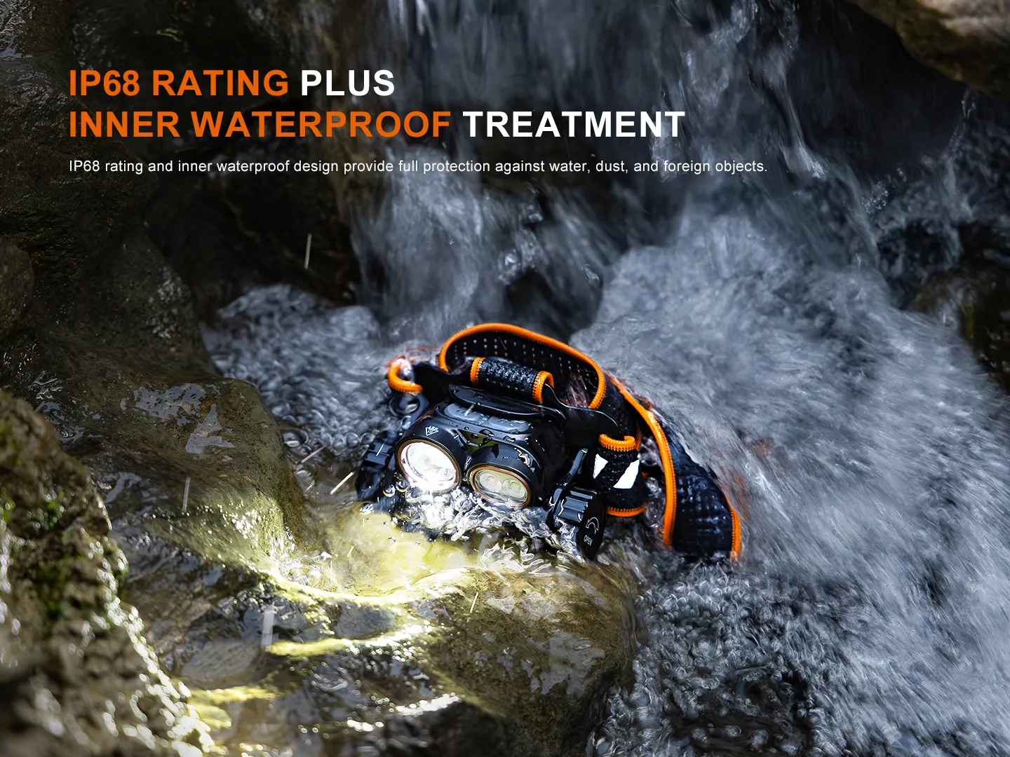 Fenix HM65R V2.0 headlamp submerged and shining brightly in a rocky, flowing stream, demonstrating IP68 waterproofing.