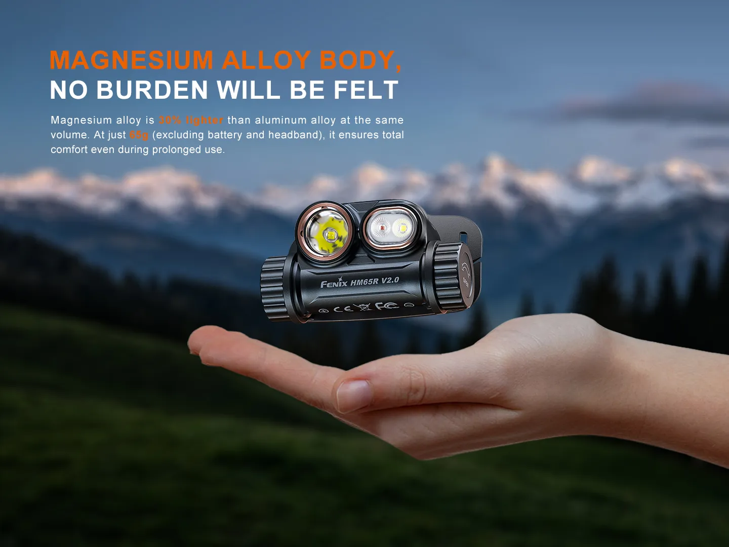 Fenix HM65R V2.0 headlamp resting on an open palm, emphasizing its lightweight magnesium alloy body against a mountain backdrop.