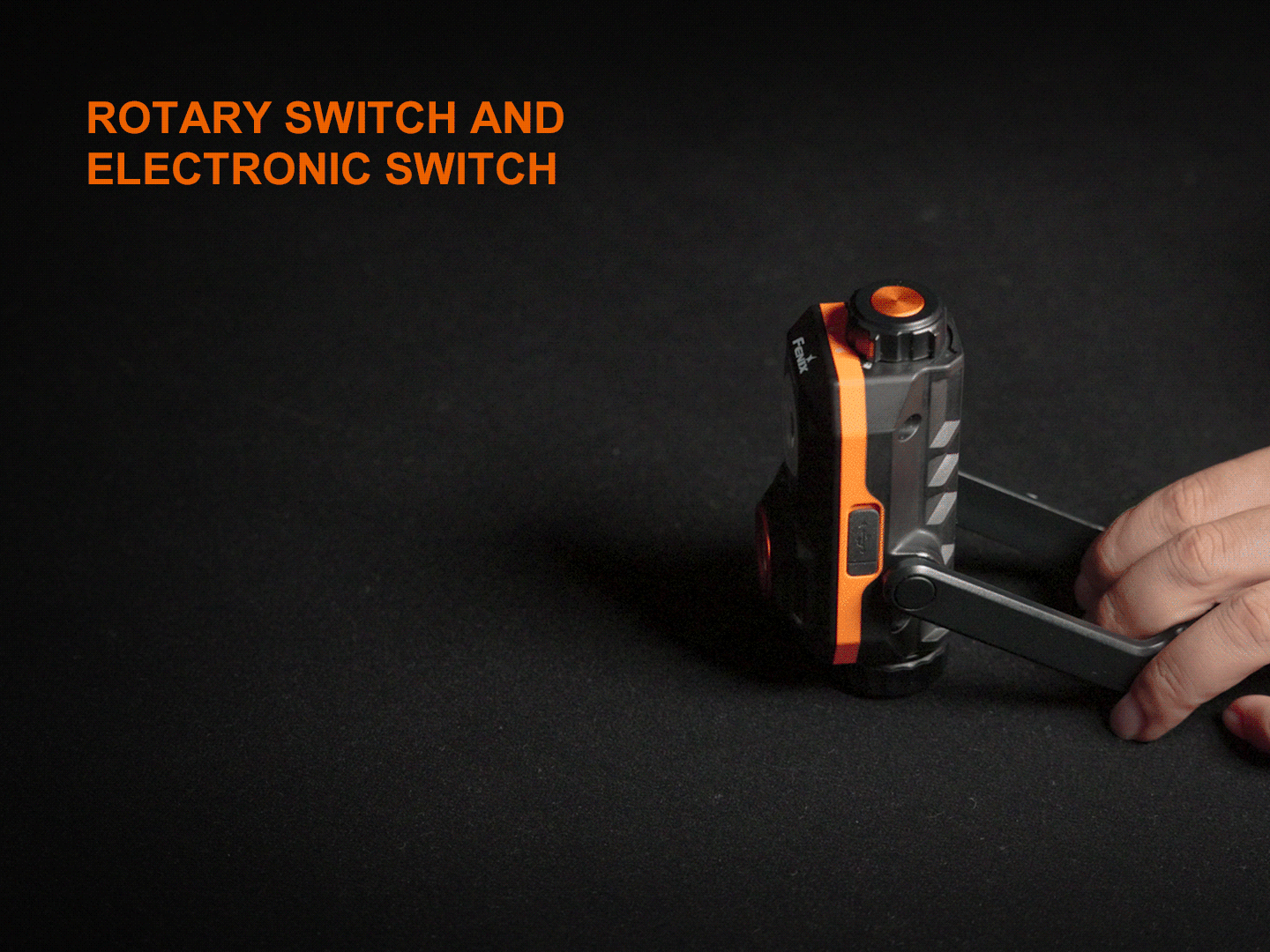 Fenix WT26RM - 2500lm High-Cri Portable Work Light with a hand adjusting its mount, showing the switches.