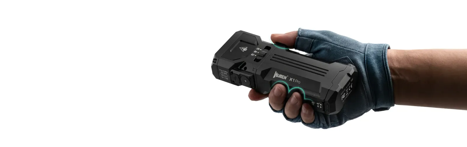 A gloved hand holding the black NUBEN X1Pro flashlight, highlighting its ergonomic design and controls.