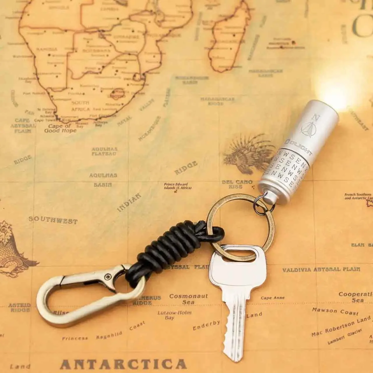 Olight i1R 2 Pro Cardinal Directions Limited Edition 180 Lumen Keychain Light (North) attached to a key on a map.