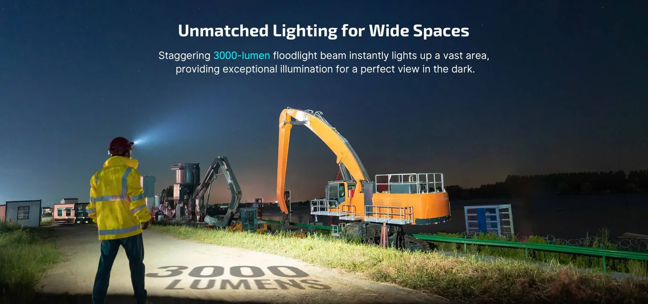 Man wearing Olight Perun 3 High Performance 3000 lumen rechargeable headlamp, illuminating a wide construction site at night.