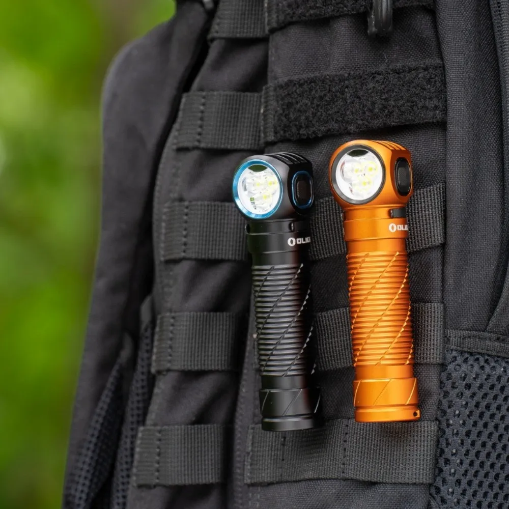 Black and orange Olight Perun 3 High Performance 3000 lumen rechargeable headlamps clipped onto a backpack.