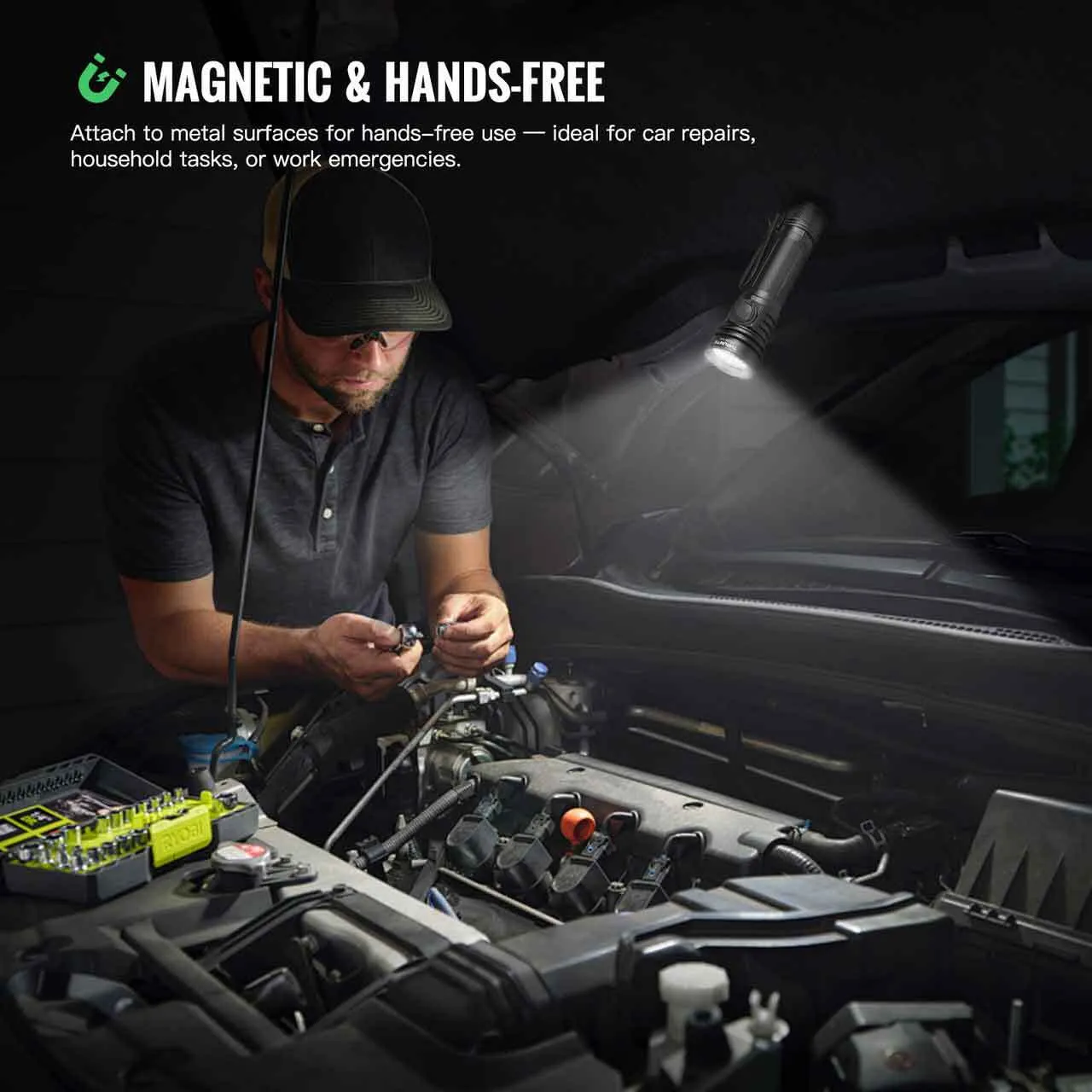 Man using the magnetic ThruNite TC20 V3 flashlight hands-free, attached to a car hood for repairs.