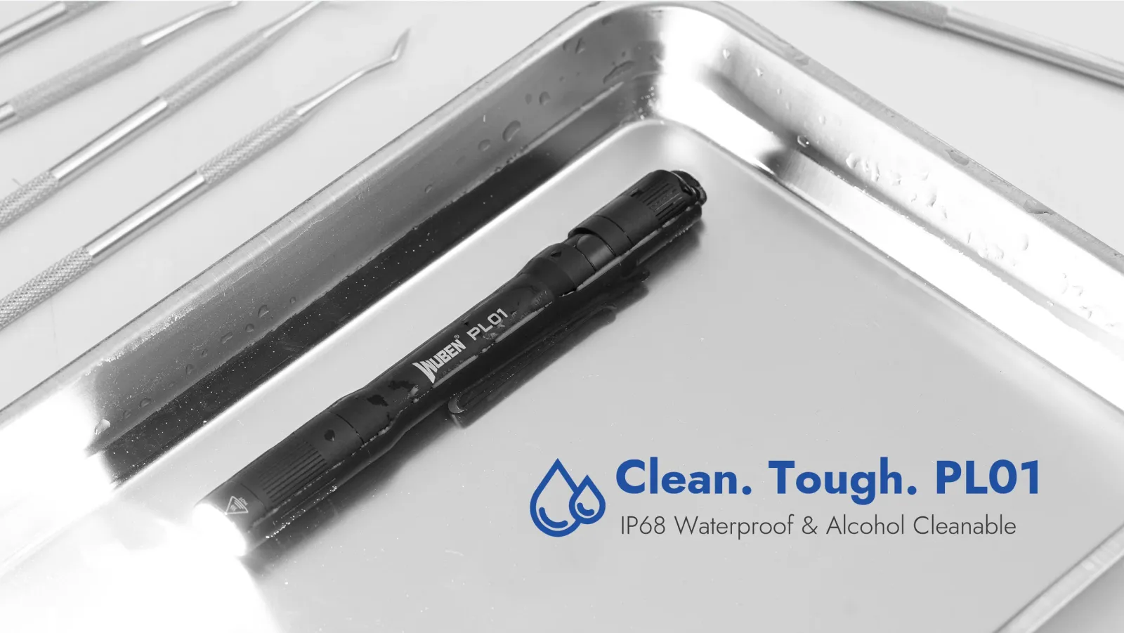Wuben PL01 penlight in a wet metal tray with medical tools, highlighting its IP68 waterproof and alcohol cleanable features.