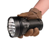 Acebeam X25 powerful LED flashlight held in a gloved hand, demonstrating its ergonomic grip.