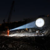 Acebeam Terminator M1 2.0 - 1.6km Zoomable LEP Spotlight and LED Floodlight with Red in use at night.