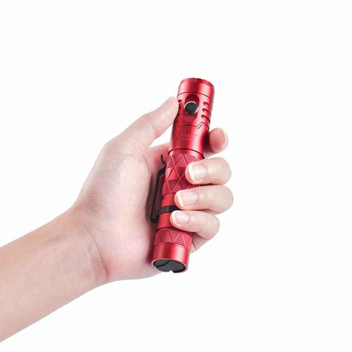 Red Wuben E12R flashlight held comfortably in a person's hand, demonstrating its compact size.