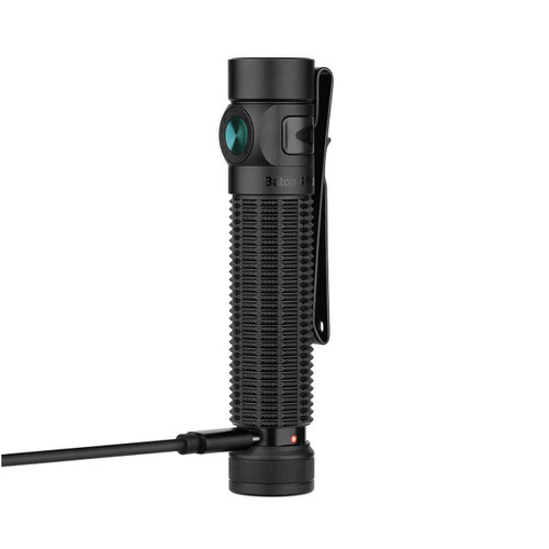 Black Olight Baton 4 Pro flashlight charging via USB-C cable plugged into the tailcap, red indicator light.