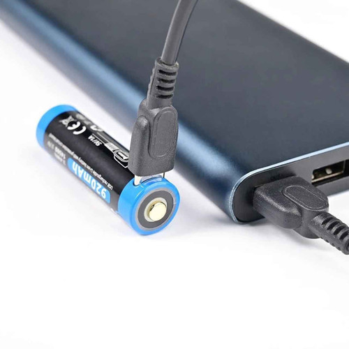 Wuben H1 920mAh 14500 rechargeable battery being charged via USB cable from a power bank.