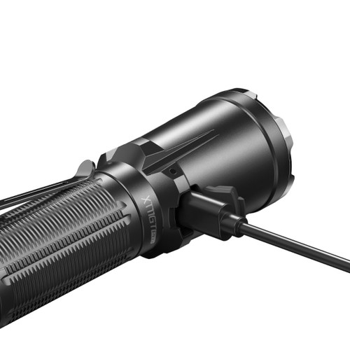 Close-up of the Klarus XT11GT Pro V3 with a USB cable plugged into its charging port.
