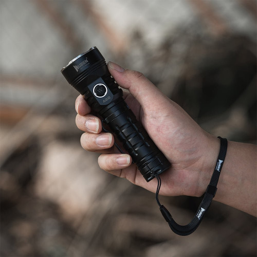 Hand holding the Wubenlight A22 4500 lumen high power rechargeable flashlight with a wrist lanyard outdoors.