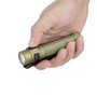 Olight Baton Ultra olive green flashlight held in a hand, highlighting its compact size.