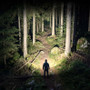 Person wearing Acebeam H18 - 4000 Lumen Quick-detach Magnetic Headlamp in a dark forest.