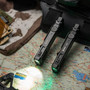 Two Wuben X5 3-in-1 1300 lumens EDC rechargeable flashlights on a map, one illuminated, demonstrating outdoor use.