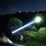 Acebeam L19 2.0 Hunting Kit - 1km+ Throw Spotlight with Mount, Filters and Holster illuminating a distant area at night.