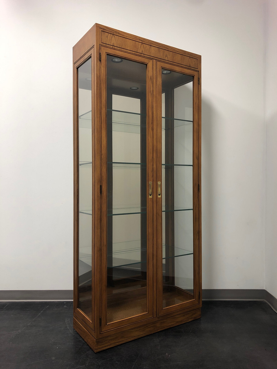 Sold Henredon Artefacts Campaign Style Illuminated Curio Cabinet