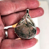 Large Green Moss Agate sterling silver pendant in my hand. 