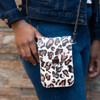 Leopard print crossbody see thru phone carrier and purse on a model. 