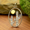Cactus and bronze sun sterling silver pendant with background. 
