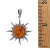 Amber sun sterling silver pendant with a ruler. 