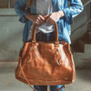 BedStu leather large Rockaway Tan Rustic bag with a model. 