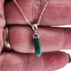 Malachite point pendant necklace in my hand.  Malachite point pendant necklace in my hand.